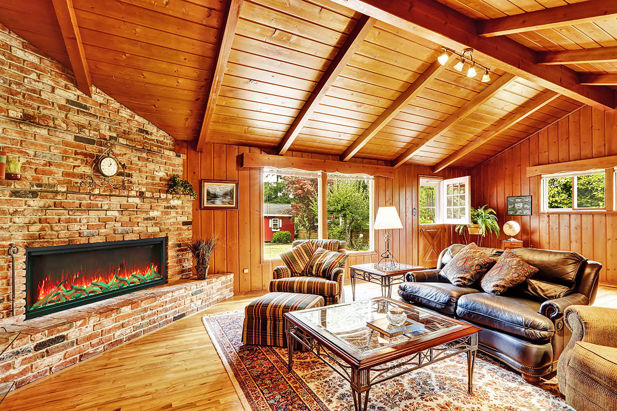 Luxury log cabin house interior. Living room with fireplace and leather couch